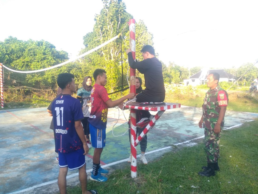 Babinsa melaksanakan kegiatan komsos di lapangan voli desa binaan